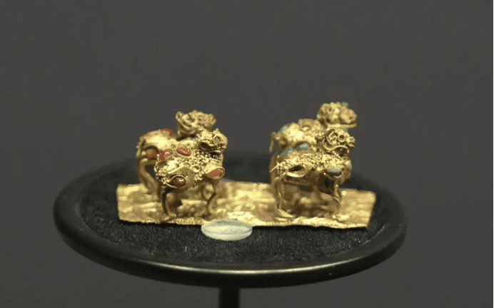 Intricate gold animal figurines displayed elegantly.