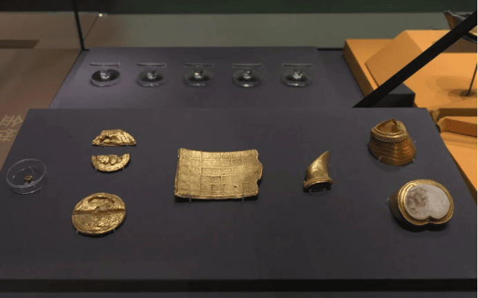 Ancient gold and silver artifacts displayed.