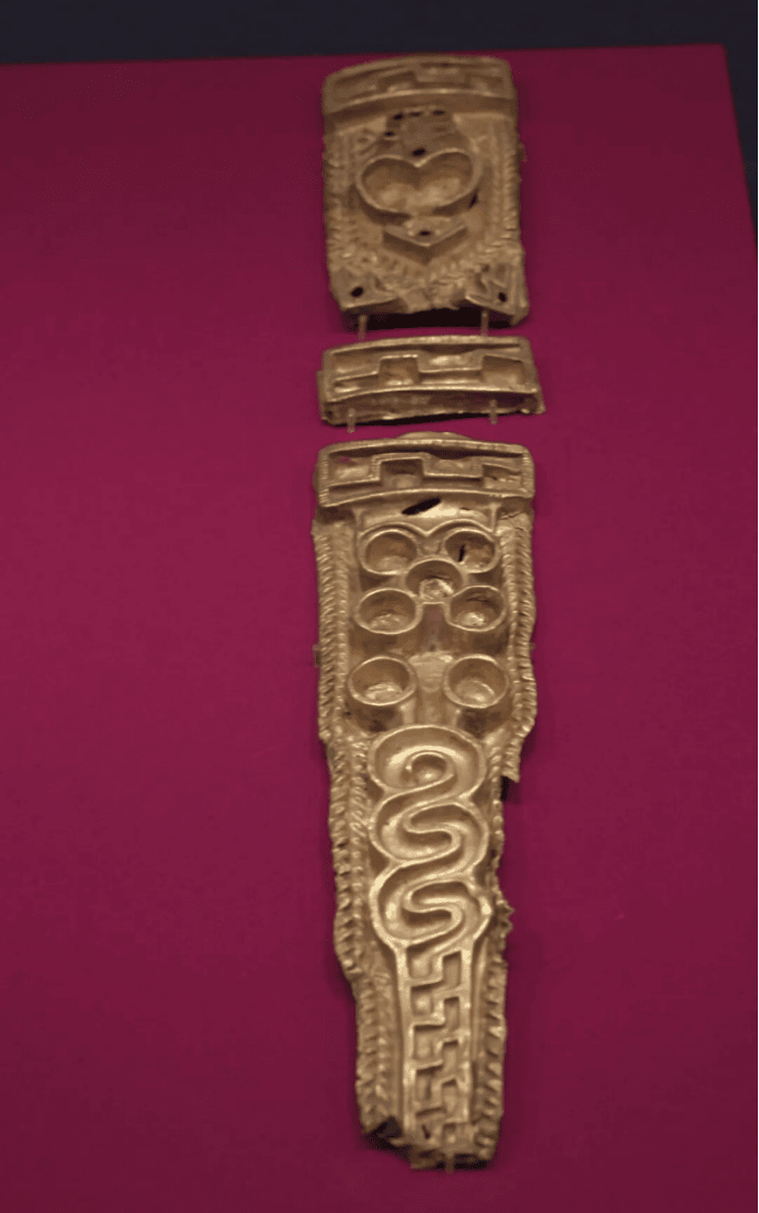 Ancient gold artifact with intricate designs.