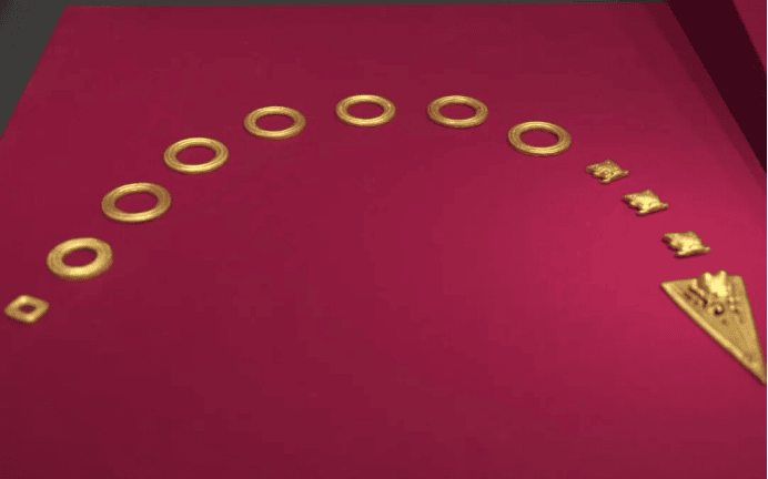 Ancient gold artifacts arranged artistically.