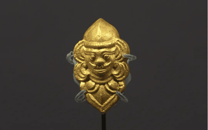 Ancient gold ornament with intricate design.