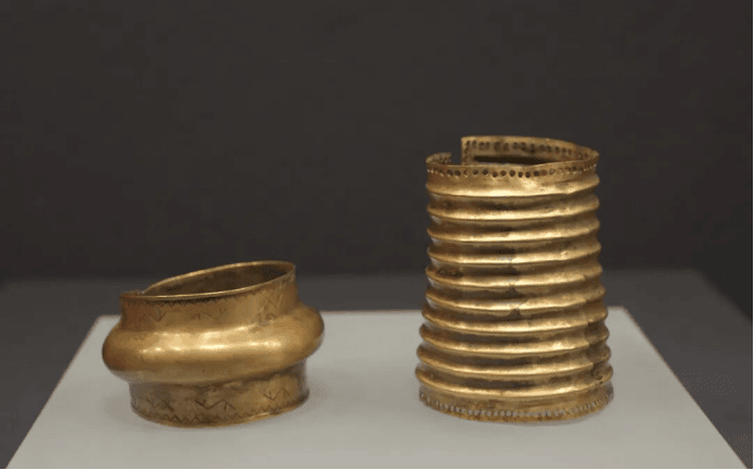 Ancient gold and silver artifacts displayed.