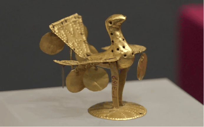 Intricate golden bird sculpture with ornaments