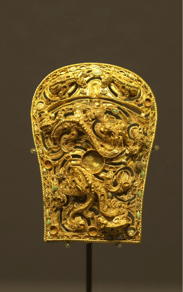 Intricate gold artifact with dragon motifs