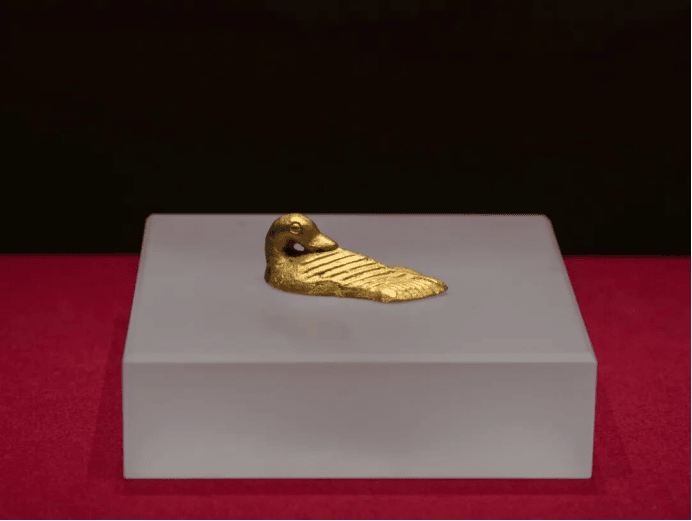 Golden duck-shaped artifact on display